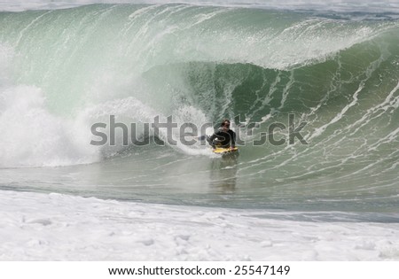 bodyboard on a huge wave