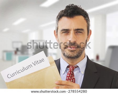 Man inside an office holding CV papers and job application documents