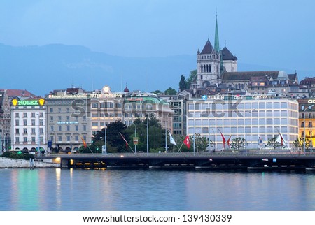 GENEVA, SWITZERLAND - MAY 24: Old town cathedral and waterfront luxury brand offices in Geneva, Switzerland on May 24, 2008. Geneva is a finance and luxury city.