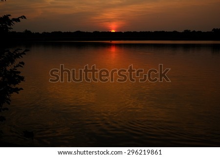 A beautiful sunset on the lake, the clouds casting shimmering shadows in the lake water