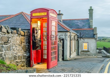 A old English telephone booth next to a pub at the Giant\'s Causeway, Northern Ireland