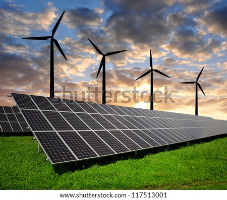 Solar panels and wind turbine in the setting sun