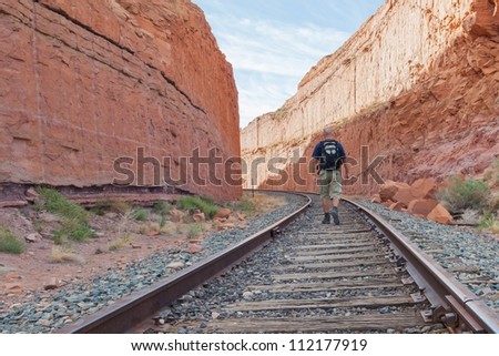 The alone man traveling on railway.