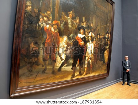 AMSTERDAM, NETHERLANDS - APRIL 3: Man guarding the famous picture The night watch from painter Rembrandt at Rijksmuseum in city Amsterdam on April 3, 2014 in Amsterdam