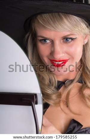 woman looks in mirror and smiling