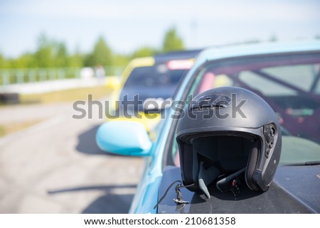 black helmet on hood of sport car