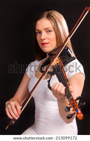 beautifu girl in white dress playing on electro violin