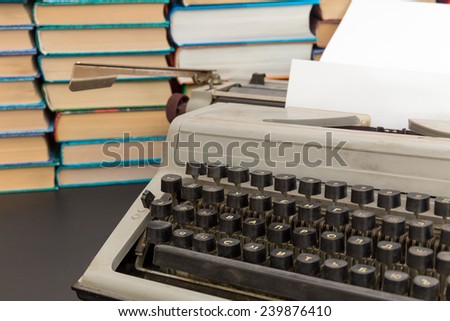 typewriter on a background of a pile of books