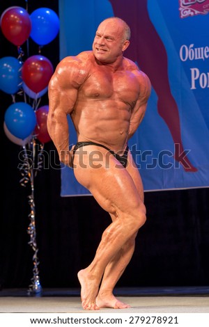Perm, Russia - April 19, 2015.Cup Perm Krai  on bodybuilding and fitness bikini. bald big bodybuilder showing triceps