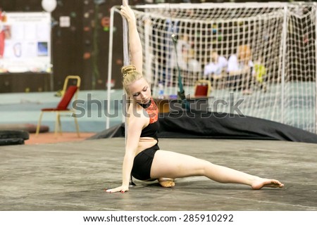 Perm, Russia - April 25, 2015. Championship Perm region at pole sport and dance. little girl blonde performs at competitions in pole dance