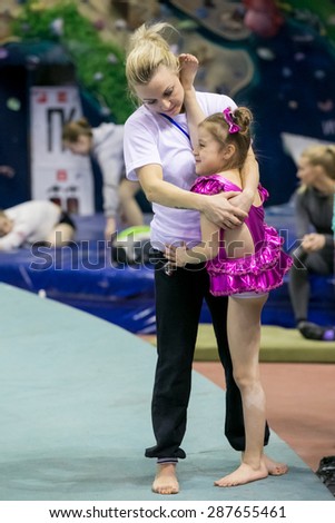 Perm, Russia - April 25, 2015. Championship Perm region at pole sport and dance. Mom trainer stretches splits her daughter before the competition
