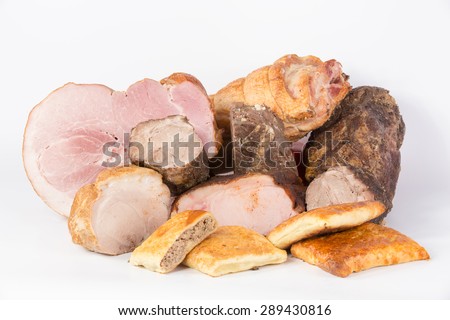 Meat delicacies and meat layer cake on white background
