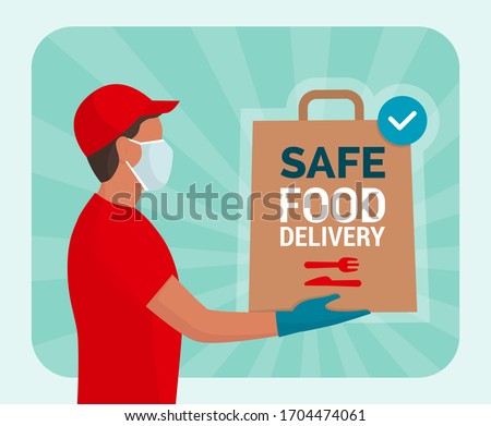 Safe food delivery at home during coronavirus covid-19 epidemic: delivery man holding a bag with fast food, he is wearing a face mask and gloves