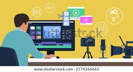 Professional videomaker, sitting at desk and editing a video using a video editing software