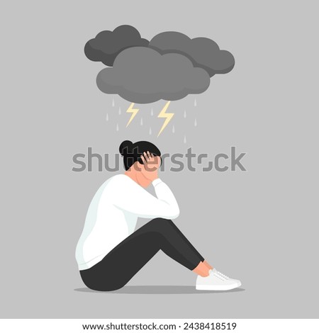 Depressed woman sitting with head in hands and dark clouds over her head, depression and mental health concept