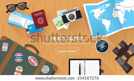 Traveler's desktop with suitcase, camera, plane ticket, passport, compass and binoculars, travel and vacations concept