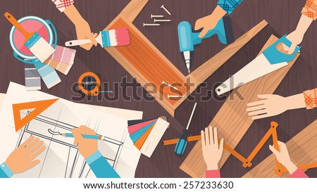 Team of workers using DIY tools and working on a carpentry project