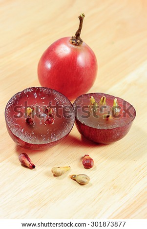 grape seeds on wood background macro closeup