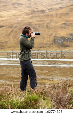 Nature photographer in the ourdoors, Highlands, Scotland, Europe