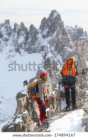 Alpinists climbing ferrata La torre di Toblin (2.617 m), Dolomites, Italy, Europe