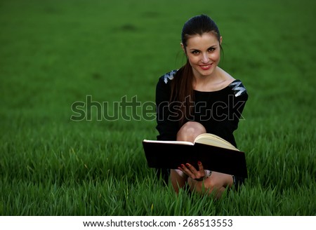 Young girl studying the agenda in the park
