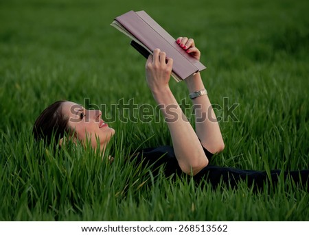 Young girl studying the agenda in the park