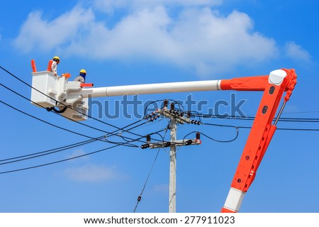 electrician working  repairing the power line on  hydraulic platform