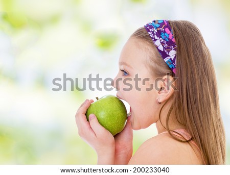 young girl biting mouth wide open green apple