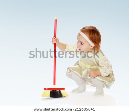young girl to learn to sweep the floor.The concept of child development