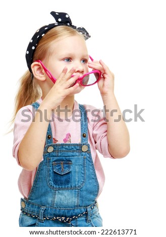 Little girl trying on glasses.Childhood education development in the Montessori school concept. Isolated on white background.