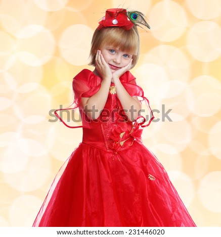 Fashionable little girl in a bright red dress . Happiness, winter holidays, new year, and childhood.