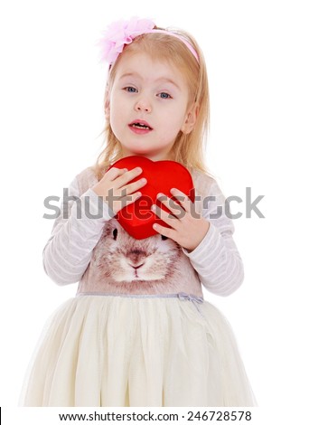 Adorable little girl hugged to his chest box in the form of heart.Isolated on white background