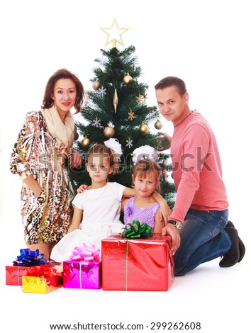 Happy family four people mom dad and two adorable little girls at the Christmas tree, in front of family, there are many colorful, beautifully Packed boxes with gifts -Isolated on white background