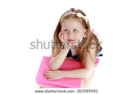 Adorable little blonde girl lies on the floor . Girl hugging a stack of books and dreams of looking up to the sky-Isolated on white background