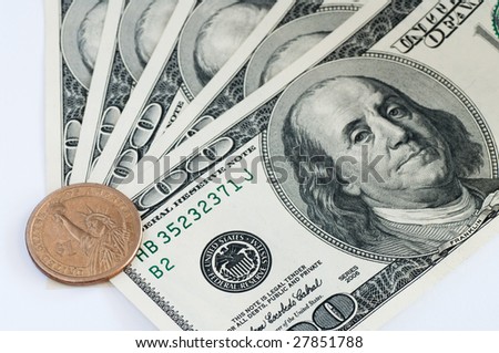 close up macro shot of 100 dollar banknotes and one dollar coin
