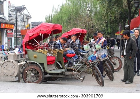 Suzhou, China, 11 November, 2014 Rickshaw drivers are waiting for passengers in the city center of water town Suzhou, province Jiangsu