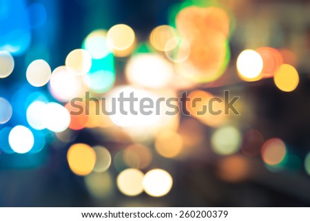 Abstract background of bokeh light at city night with vintage color tone tuned