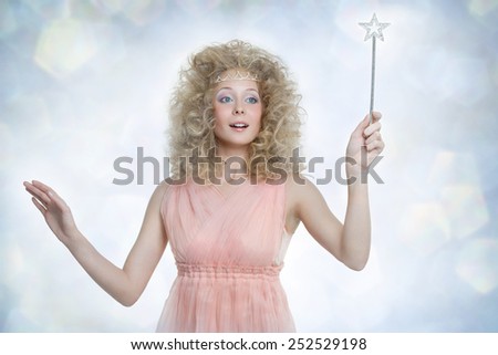 Young pretty dreaming girl with magic wand