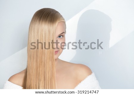 Portrait of a girl with beautiful bright clean hair on a white background