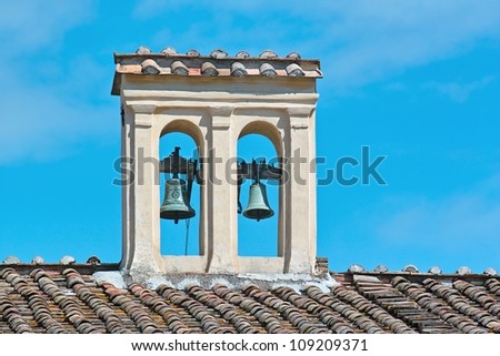 small bell tower with two bells, on a roof