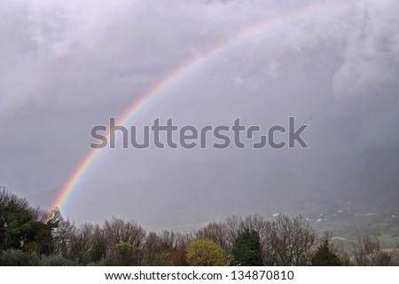 formation of a rainbow on the background of a cloudy sky