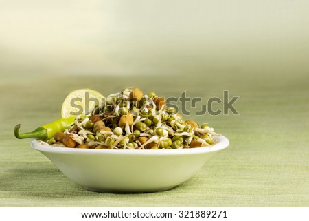 Healthy sprout served with green chillies and a lemon slice.