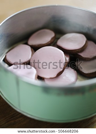 A cake tin with frosted cookies, Sweden.