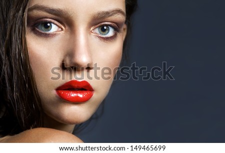 portrait of an attractive girl close-up with full red lips, perfect tanned skin, rich shades red lips, foundation,snazzy look