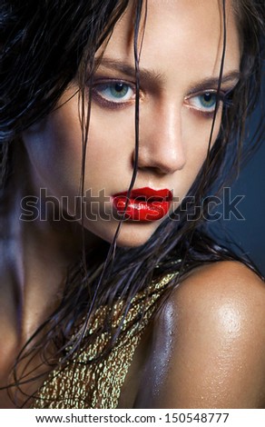 portrait of a young beauty girl with full red lips and perfect tanned wet skin. Shine make up.  tan ,perfect skin