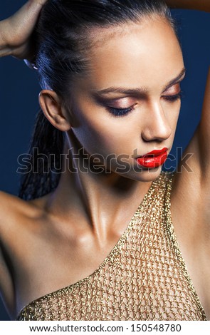 portrait of a young beauty girl with full red lips and perfect tanned wet skin. Shine make up.  tan ,perfect skin