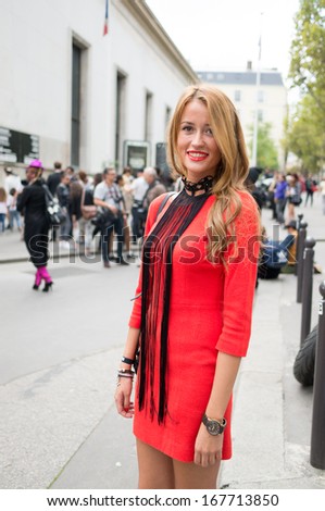 PARIS - OCTOBER 2, 2013: Stylish woman wears red dress during the Paris Fashion Week. Paris Fashion Week is a clothing trade show held semi-annually each year in Paris, France.