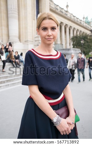 PARIS - OCTOBER 2: Stylish woman during the Paris Fashion Week on October 2, 2013 in Paris, France. Paris Fashion Week is a clothing trade show held semi-annually each year in Paris, France.