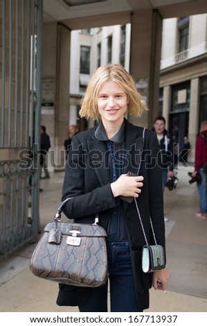 PARIS - OCTOBER 2, 2013: Stylish woman wears leather bag during the Paris Fashion Week. Paris Fashion Week is a clothing trade show held semi-annually each year in Paris, France.