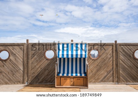 Chair with blue and withe parasol on the beach, Houlgate, Normandy, France